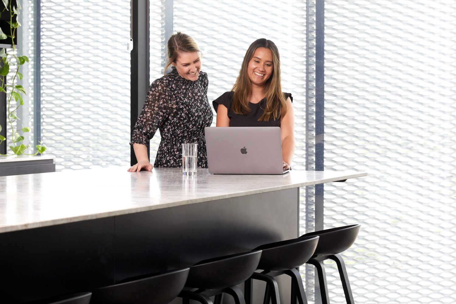 two mortgage brokers looking at a laptop boost borrowing power